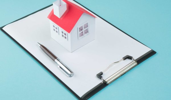 small-house-model-pen-blank-clipboard-blue-backdrop (1)